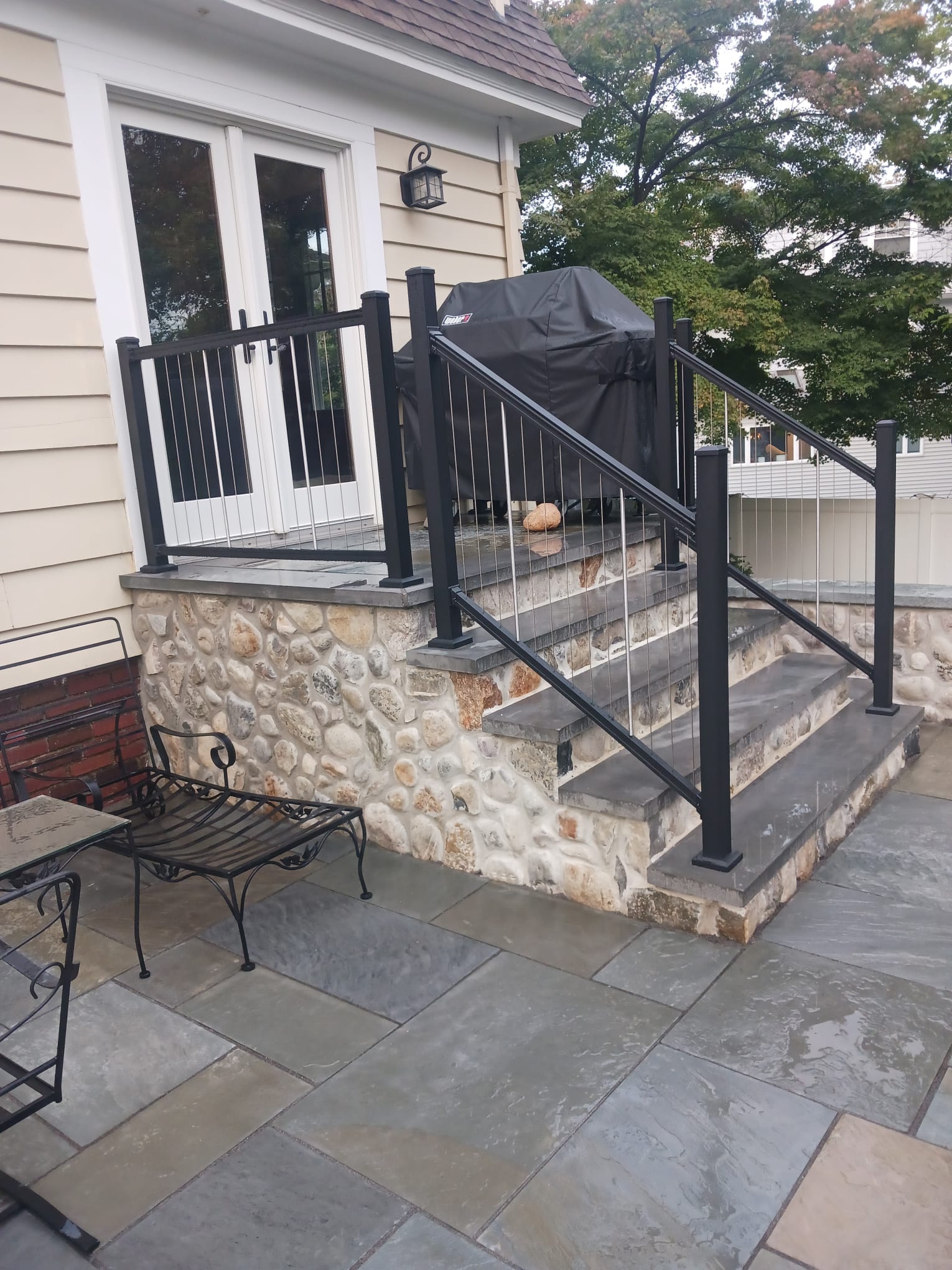 Exterior stone patio and railing
